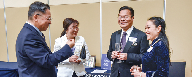 Four alumni parents at a community event in Beijing